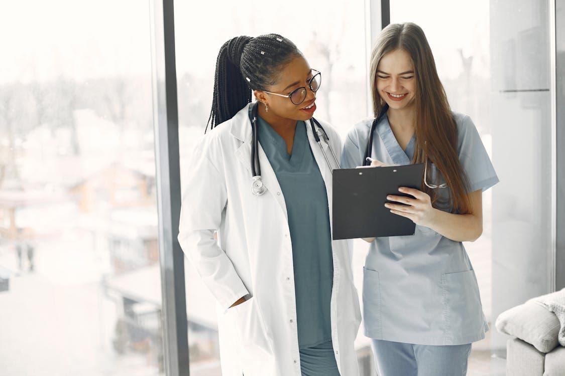 Healthcare professionals looking at a document on a clipboard